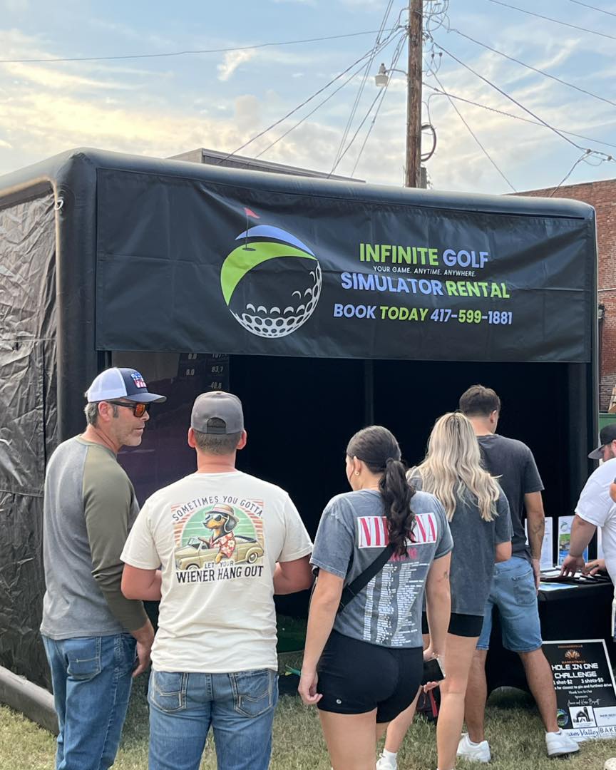 Guests gathered outside the branded Infinite Golf simulator rental booth