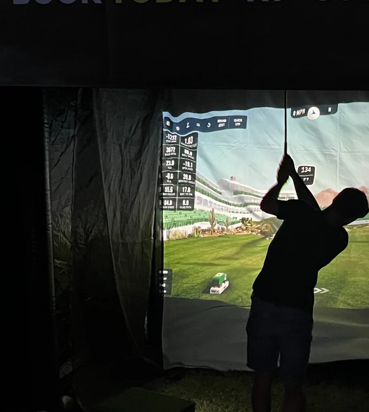 Guest swinging on simulator at night